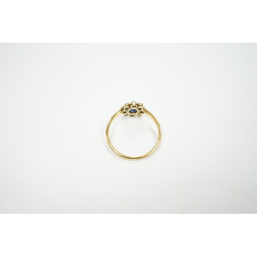 975 - An 18ct, sapphire and diamond cluster set oval ring, size M, gross weight 2 grams.