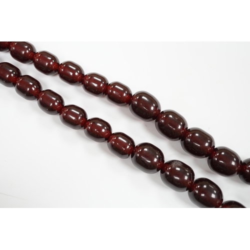 980 - A single strand graduated simulated cherry amber bead necklace, 68cm, gross weight 151 grams.