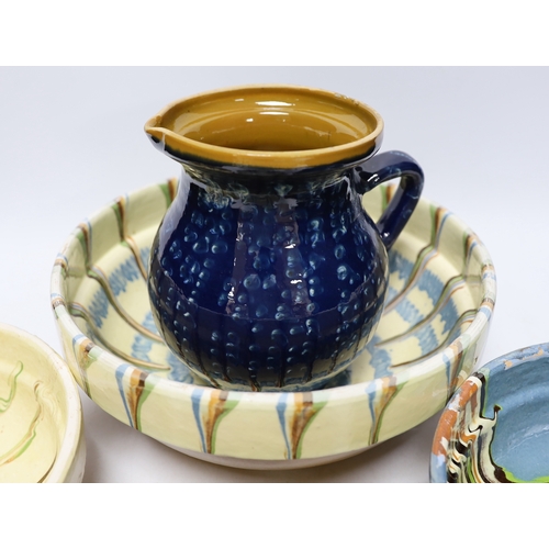 436 - Four drizzle glazed pottery bowls and a dark glazed jug, largest bowl 26cm diameter (5)