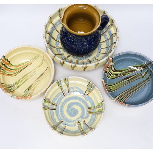 436 - Four drizzle glazed pottery bowls and a dark glazed jug, largest bowl 26cm diameter (5)