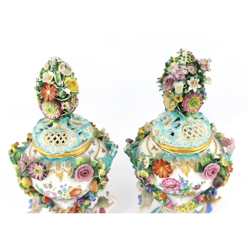 130 - A pair of Meissen topographical flower encrusted vases and covers, 19th century, each painted with t... 