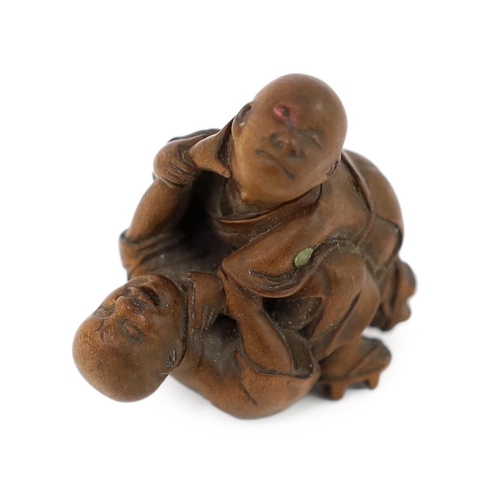 150 - * * A Tokyo School carved wood netsuke of two boys fighting, 19th century, signed Kakiman, one boy w... 