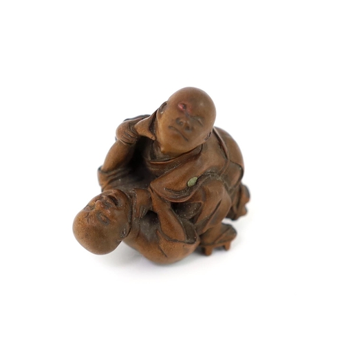 150 - * * A Tokyo School carved wood netsuke of two boys fighting, 19th century, signed Kakiman, one boy w... 