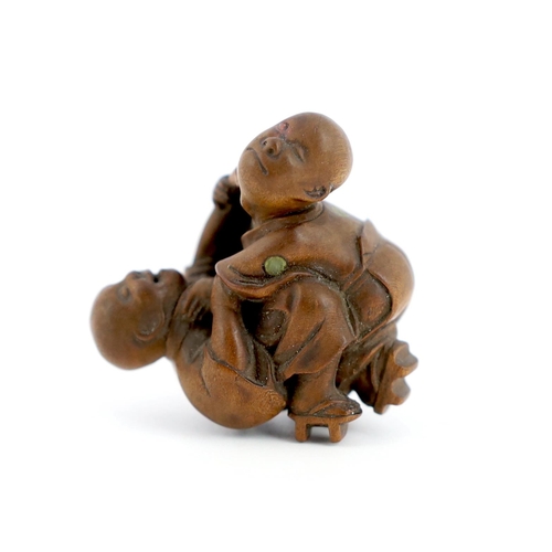 150 - * * A Tokyo School carved wood netsuke of two boys fighting, 19th century, signed Kakiman, one boy w... 