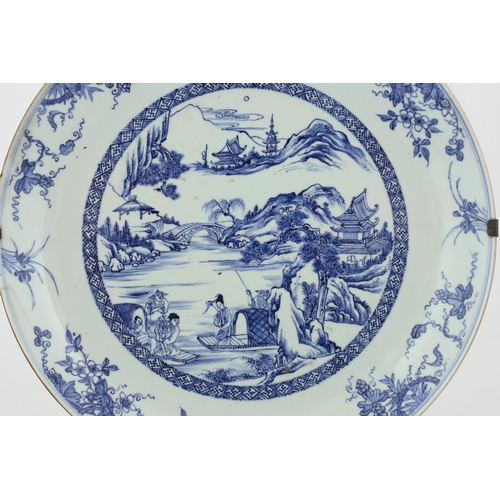 159 - A Chinese blue and white landscape dish, Yongzheng/Qianlong period, finely drawn and painted with fi... 