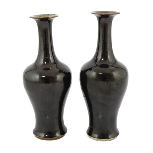 162 - A near pair of Chinese mirror-black glazed vases, Kangxi period, each with a trumpet shaped neck abo... 