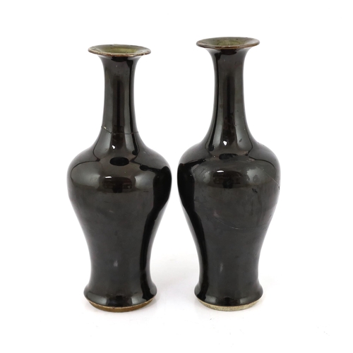 162 - A near pair of Chinese mirror-black glazed vases, Kangxi period, each with a trumpet shaped neck abo... 