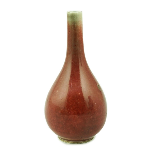 167 - A Chinese copper red small bottle vase, 18th/19th century, of pear shape, underglaze blue double cir... 