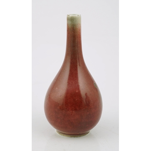 167 - A Chinese copper red small bottle vase, 18th/19th century, of pear shape, underglaze blue double cir... 