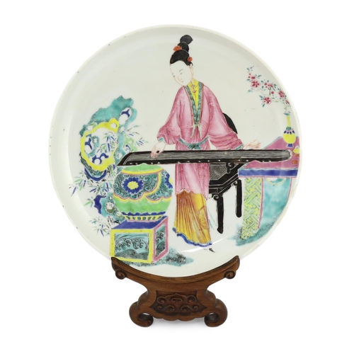 170 - * * A Chinese famille rose saucer dish, Yongzheng period, painted in enamels with a young woman play... 