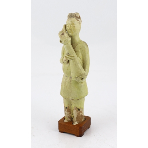 171 - * * A Chinese pale green glazed pottery figure of an attendant, Tang dynasty (618-906 AD), standing ... 