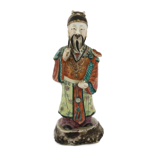 181 - A Chinese enamelled porcelain figure of a court official, Jiaqing period (1796-1820), standing and h... 