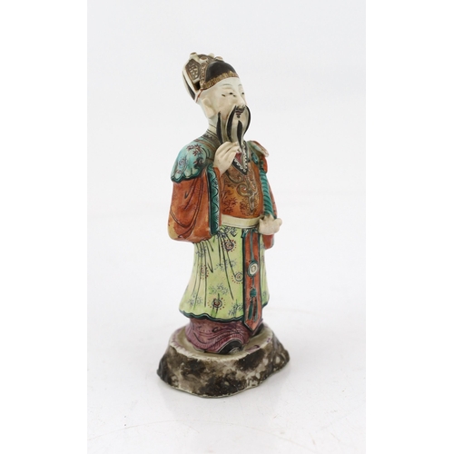 181 - A Chinese enamelled porcelain figure of a court official, Jiaqing period (1796-1820), standing and h... 