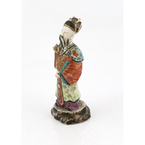 181 - A Chinese enamelled porcelain figure of a court official, Jiaqing period (1796-1820), standing and h... 