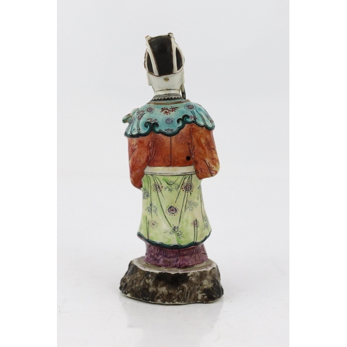 181 - A Chinese enamelled porcelain figure of a court official, Jiaqing period (1796-1820), standing and h... 