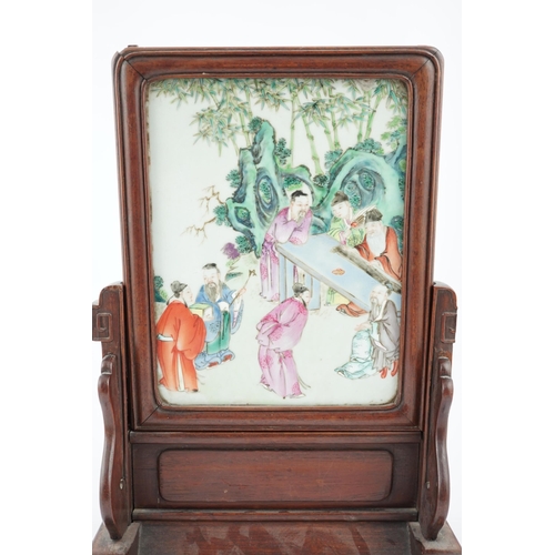 186 - A Chinese famille rose porcelain mounted hongmu framed table screen, 19th century, the porcelain pla... 