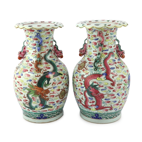 191 - A pair of Chinese enamelled porcelain 'dragon and Buddhist lion' vases, 19th century, each painted w... 