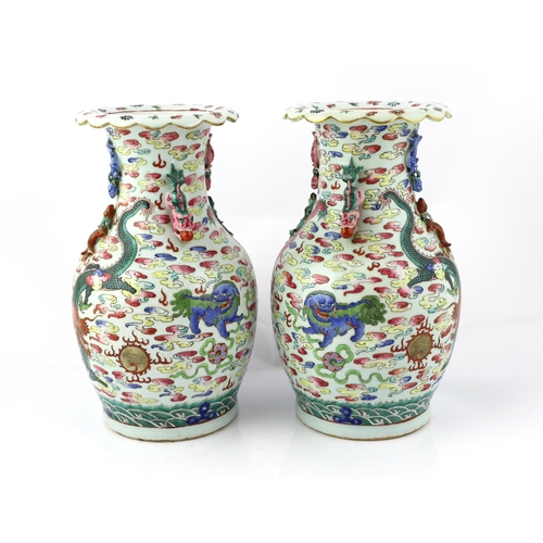 191 - A pair of Chinese enamelled porcelain 'dragon and Buddhist lion' vases, 19th century, each painted w... 