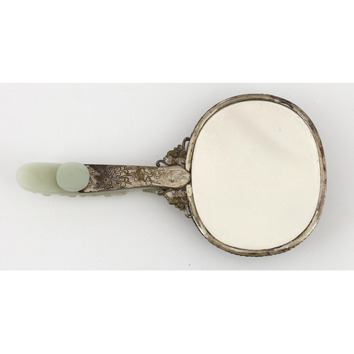 211 - A Chinese celadon jade mounted hand mirror, the jade 18th/19th century, the back of the mirror cast ... 