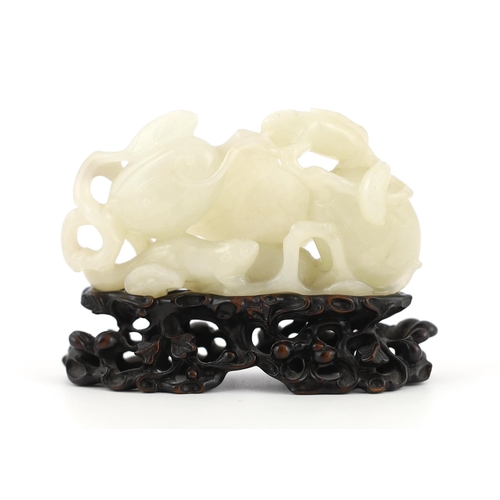 213 - * * A Chinese white jade carving of a cluster of melons, 18th century, with stalks and leaves, two s... 