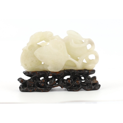 213 - * * A Chinese white jade carving of a cluster of melons, 18th century, with stalks and leaves, two s... 