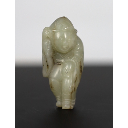 215 - * * A Chinese white jade figure of a boy wearing a hat and long coat, Ming dynasty, the stone with b... 