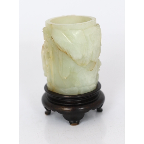 224 - * * A Chinese pale celadon and russet jade brush pot, bitong, 18th century, worked in deep relief wi... 