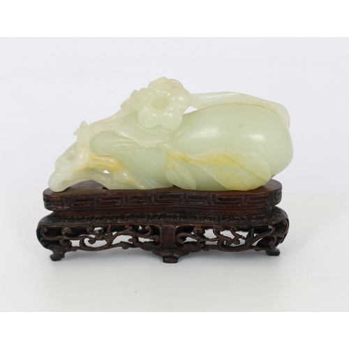 225 - * * A Chinese pale celadon jade carving of a fruit, 18th century, with stalks and leaves, a flower t... 