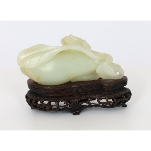 225 - * * A Chinese pale celadon jade carving of a fruit, 18th century, with stalks and leaves, a flower t... 