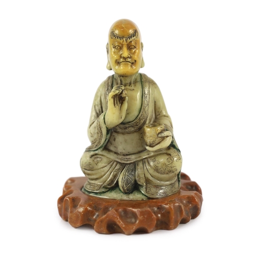 226 - A Chinese soapstone seated figure of a luohan, 18th century, seated holding a begging bowl in his le... 