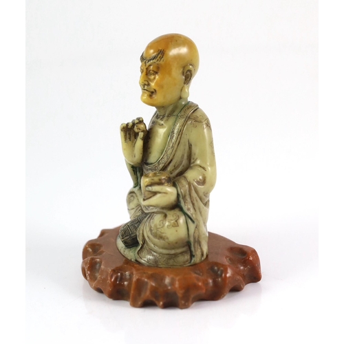 226 - A Chinese soapstone seated figure of a luohan, 18th century, seated holding a begging bowl in his le... 