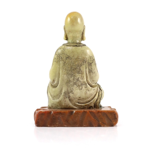 226 - A Chinese soapstone seated figure of a luohan, 18th century, seated holding a begging bowl in his le... 