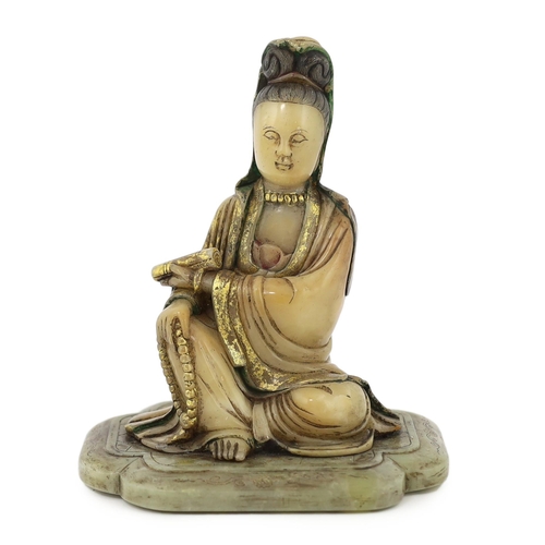 227 - A Chinese soapstone seated figure of Guanyin, 17th/18th century, holding a scroll in the left hand a... 