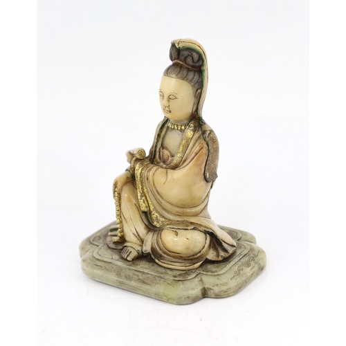 227 - A Chinese soapstone seated figure of Guanyin, 17th/18th century, holding a scroll in the left hand a... 