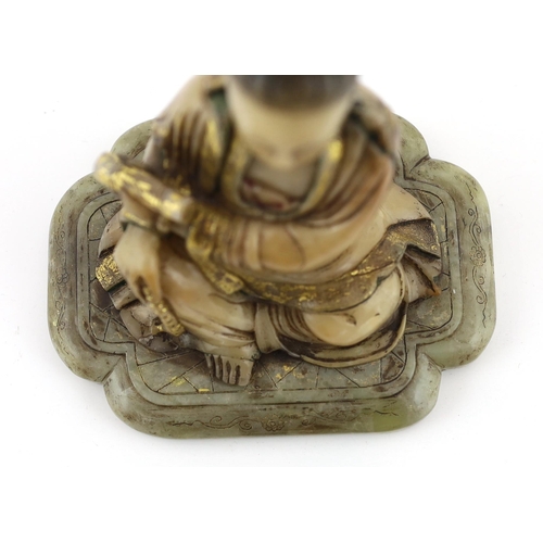 227 - A Chinese soapstone seated figure of Guanyin, 17th/18th century, holding a scroll in the left hand a... 