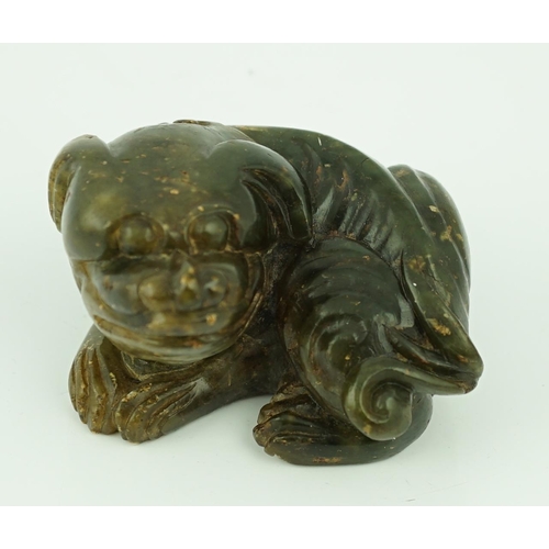 234 - A Chinese Ming green soapstone figure of a recumbent lion-dog, 16th/17th century, 7.5cm long