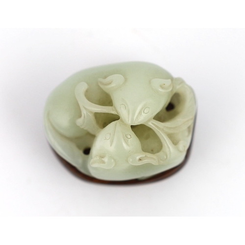 238 - A Chinese pale celadon jade group of two badgers, 18th/19th century, each biting a sprig of lingzhi ... 