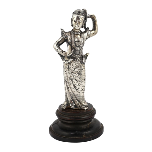 242 - A Burmese cast silver model of a dancer, late 19th century, on an ebonised wood plinth, total height... 