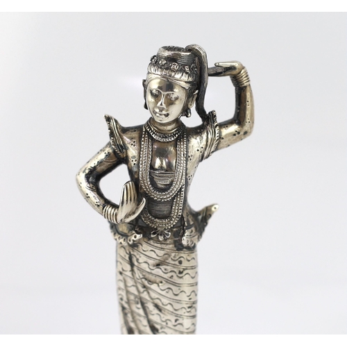 242 - A Burmese cast silver model of a dancer, late 19th century, on an ebonised wood plinth, total height... 