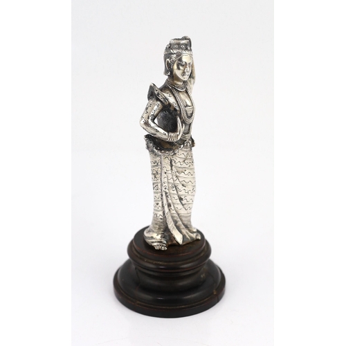 242 - A Burmese cast silver model of a dancer, late 19th century, on an ebonised wood plinth, total height... 