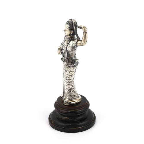 242 - A Burmese cast silver model of a dancer, late 19th century, on an ebonised wood plinth, total height... 