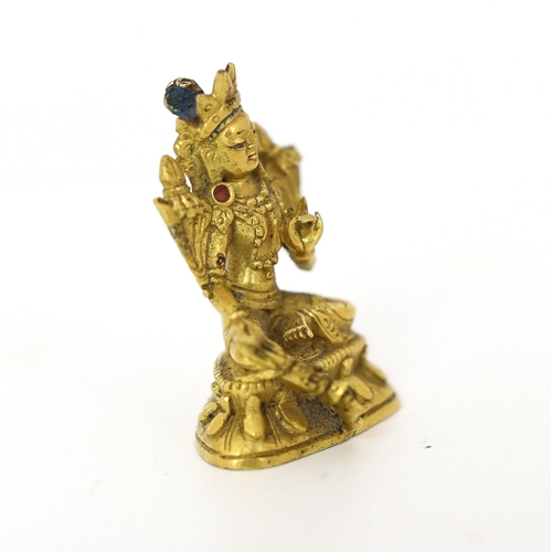 245 - * * A Tibetan miniature gilt bronze figure of Green Tara, 18th/19th century, 3cm highProvenance: G. ... 