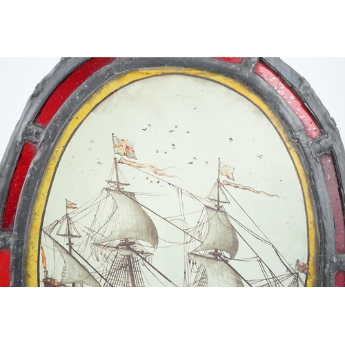 59 - An early 18th century stained glass panel, depicting a warship off the coast, within a later red gla... 