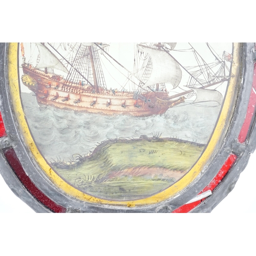 59 - An early 18th century stained glass panel, depicting a warship off the coast, within a later red gla... 