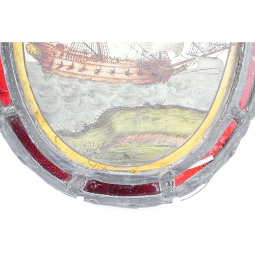 59 - An early 18th century stained glass panel, depicting a warship off the coast, within a later red gla... 