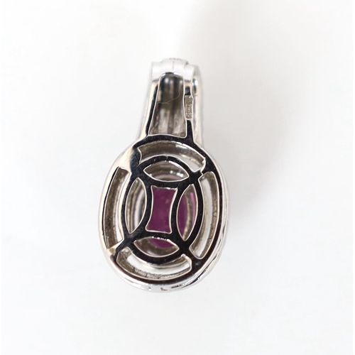 619 - A modern 14ct white gold, pink sapphire and diamond set oval cluster pendant, with four row diamond ... 