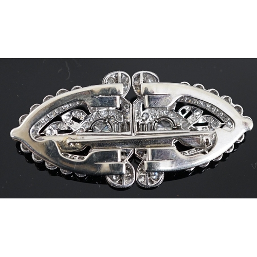 620 - An Art Deco white gold, round and baguette cut diamond set double clip brooch, the largest stones wi... 