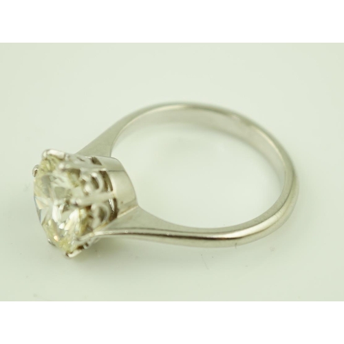 623 - A platinum and solitaire diamond set ring, the round cut stone weighing approximately 2.50ct, with a... 