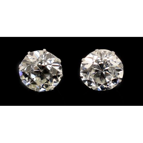 624 - A pair of early 20th century platinum and claw set diamond ear studs, the Old European cut stones wi... 