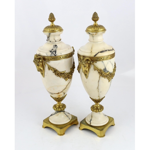 84 - A pair of Italian ormolu mounted calacaita marble urns, with fruiting finials and ram's head and swa... 